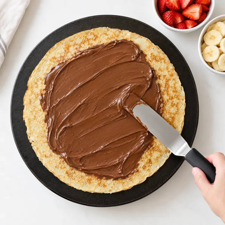 Nutella spread over a golden crêpe